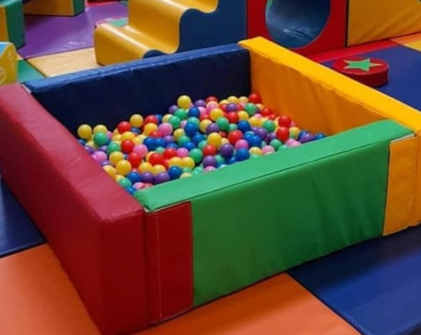 A soft padded square with plastic balls in the middle - a kids ball pit